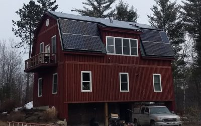 Solar Panels on tall building's metal roof.