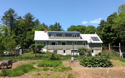 House with Solar Panels on roof with garden in front